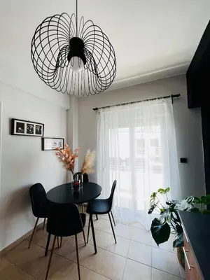 a dining room with a table and chairs and a chandelier at DownTown Apartments in Rhodes Town