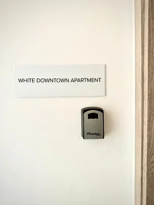 a sign on a door that reads white downtown apartment at DownTown Apartments in Rhodes Town