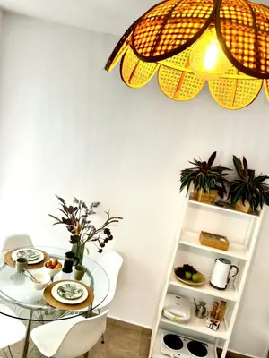 a dining room with a table and a chandelier at DownTown Apartments in Rhodes Town