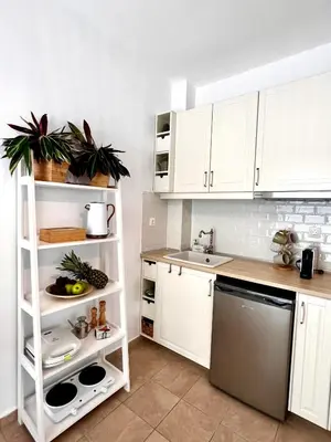 a kitchen with white cabinets and a sink and a dishwasher at DownTown Apartments in Rhodes Town