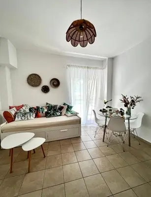 a living room with a couch and a table at DownTown Apartments in Rhodes Town