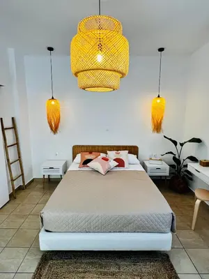 a bedroom with a bed and two lights at DownTown Apartments in Rhodes Town