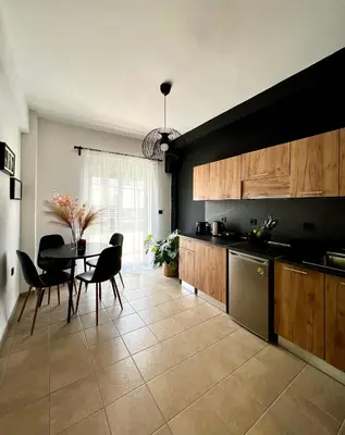 a kitchen with a table and chairs and a dining room at DownTown Apartments in Rhodes Town