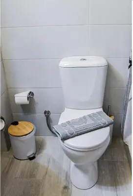 a bathroom with a toilet with a towel on it at Stone Living Symi Central Apartments in Symi