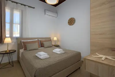 a bedroom with a bed with two towels on it at Villa Dorinna in Lachania