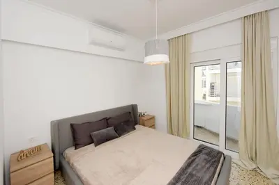 a bedroom with a bed and a large window at Naya Ixia Rhodes Apartment in Ixia
