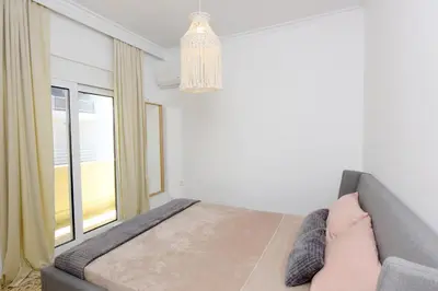 a bedroom with a couch and a large window at Naya Ixia Rhodes Apartment in Ixia