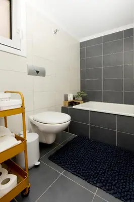a bathroom with a toilet and a bath tub at Naya Ixia Rhodes Apartment in Ixia