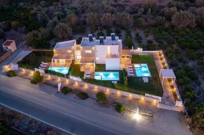 an aerial view of a building with lights at New Loft by Ossiano Pool Villas, Heating Pool,2 min drive to Haraki Beach & 10 to Lindos in Haraki