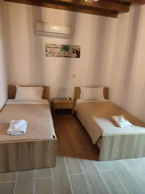 two beds sitting in a room with at Villa Jimmy, Pilona Village in vlicha