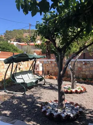 a park with a swing and a tree at Villa Jimmy, Pilona Village in vlicha