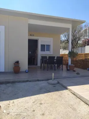 a house with a patio with a table and chairs at Stegna Holiday in Archangelos