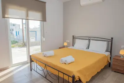 a bedroom with a bed with two towels on it at Stegna Holiday in Archangelos