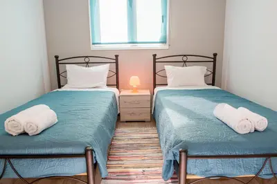 two beds in a bedroom with towels on them at Stegna Holiday in Archangelos