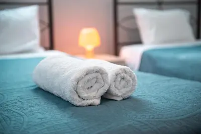 a towel sitting on top of a bed at Stegna Holiday in Archangelos
