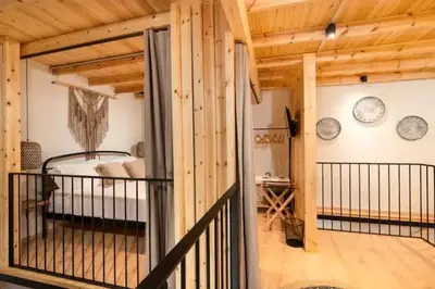 a room with a bed and clocks on the wall at Kyrangelo Traditional House with outdoor jacuzzi in Koskinou