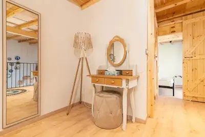 a room with a dressing table and a mirror at Kyrangelo Traditional House with outdoor jacuzzi in Koskinou