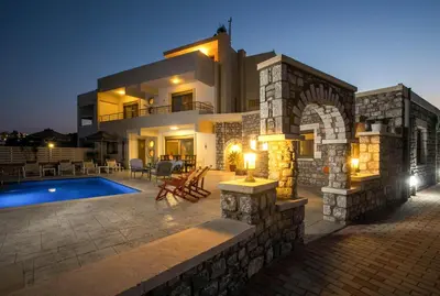 a villa with a swimming pool at night at Des & Coo Luxury Villa with Private Pool in Faliraki