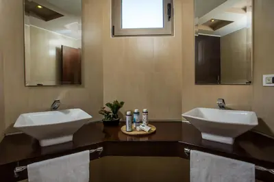 a bathroom with two sinks and two mirrors at Des & Coo Luxury Villa with Private Pool in Faliraki