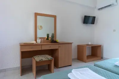 a room with a dressing table and a mirror at Yiasemi Faliraki Rooms in Faliraki