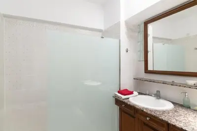 a bathroom with a sink and a mirror at House of Flowers in Rhodes Town