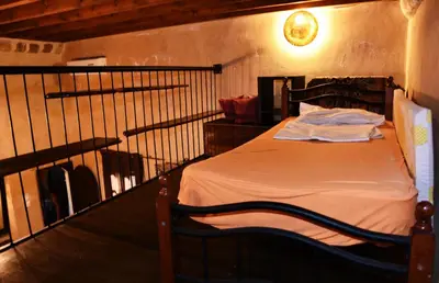 a bedroom with a bed with a black railing at The Dragon of Rodos in Rhodes Town