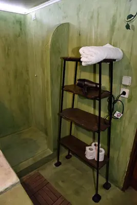 a shower with a wooden shelf in a bathroom at The Dragon of Rodos in Rhodes Town
