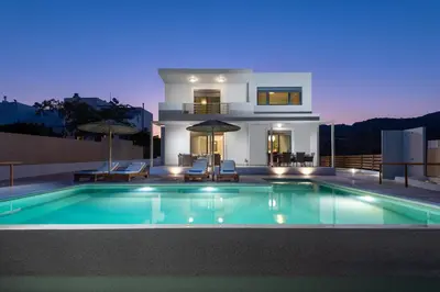 a house with a swimming pool in front of a house at Acro Villa in Afantou