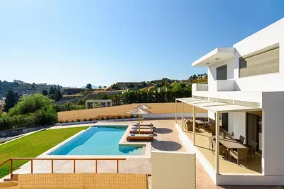 a villa with a swimming pool and a house at Acro Villa in Afantou