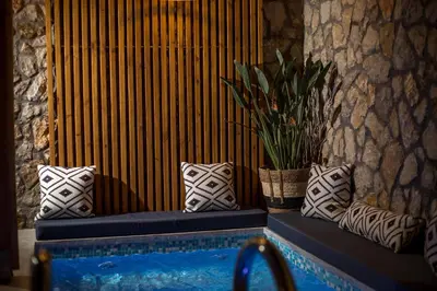 a blue bench with pillows and a potted plant at Demar luxury villa in Rhodes Town