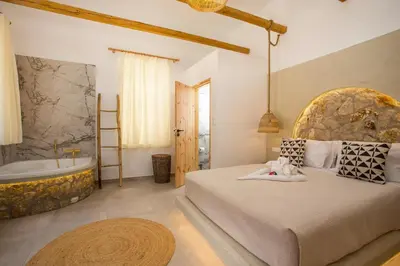 a bedroom with a large bed and a bath tub at Demar luxury villa in Rhodes Town