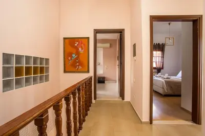a hallway with a staircase leading to a bedroom at Villa Hriska in Ixia