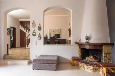 a living room with a fireplace and a mirror at Villa Hriska in Ixia
