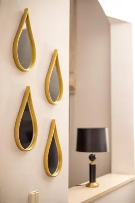 a mirror on a wall with a lamp and a lamp at Villa Hriska in Ixia