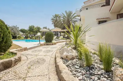 a house with a swimming pool and a yard at Villa Hriska in Ixia