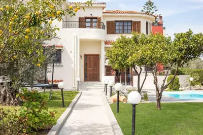 a villa with a swimming pool and a house at Villa Hriska in Ixia