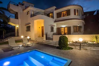 a large house with a swimming pool in front of it at Villa Hriska in Ixia