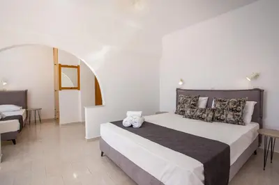 a bedroom with a large bed and a table at Anastasia Private Pool Apartment in Afantou