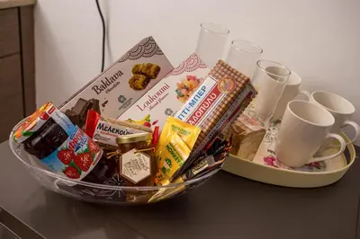 a basket of food and drinks on a table at Anastasia Private Pool Apartment in Afantou