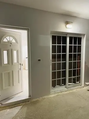 a white door and a window in a room at Anastasia Apartment in Afantou