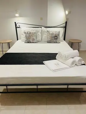 a bedroom with a bed with towels on it at Anastasia Apartment in Afantou