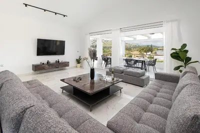 a living room with a couch and a table at Villa Nikoli in Kolimbia