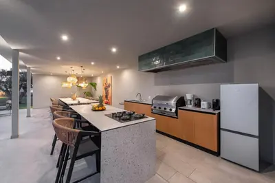 a kitchen with a counter top and a refrigerator at Villa Nikoli in Kolimbia