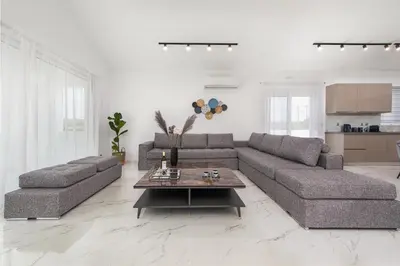 a living room with two couches and a coffee table at Villa Nikoli in Kolimbia