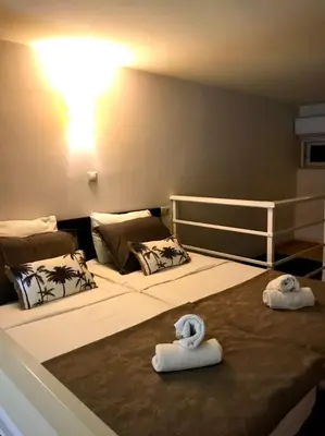 two towels on a bed in a room at Faliraki Seadream apartment,50m from the beach in Faliraki