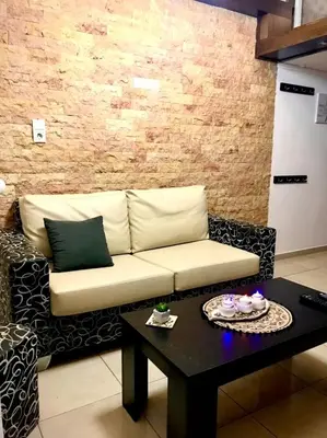 a living room with a couch and a table at Faliraki Seadream apartment,50m from the beach in Faliraki