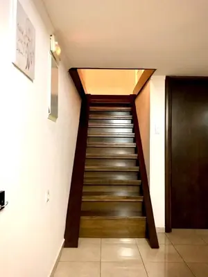a staircase leading up to a door in a building at Faliraki Seadream apartment,50m from the beach in Faliraki