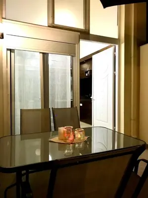 a dining room table with two candles on it at Faliraki Seadream apartment,50m from the beach in Faliraki