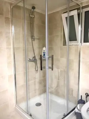 a shower with a glass door in a bathroom at Faliraki Seadream apartment,50m from the beach in Faliraki