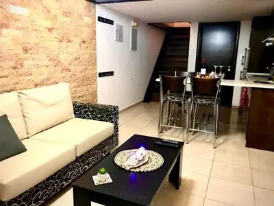a living room with a couch and a table at Faliraki Seadream apartment,50m from the beach in Faliraki